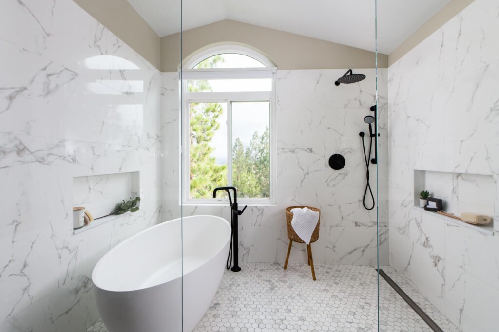 Freestanding tub in master shower remodel with spacious layout